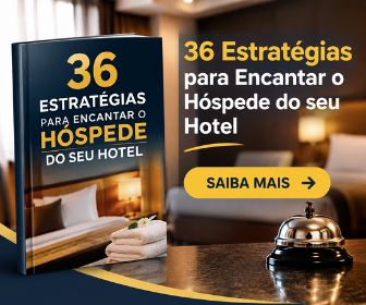 Livro digital 36 estratégias para encantar o hóspede do seu hotel ao lado de sineta metálica sobre o balcão da recepção.